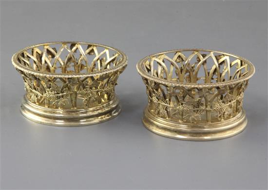 A pair of George V silver gilt bottle coasters by Pairpoint Brothers, 9 oz.
